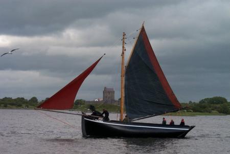 A Galway Hooker boat at Crinniú na mBad festival, Kinvara. Dunguaire Castle can be seen in the background.